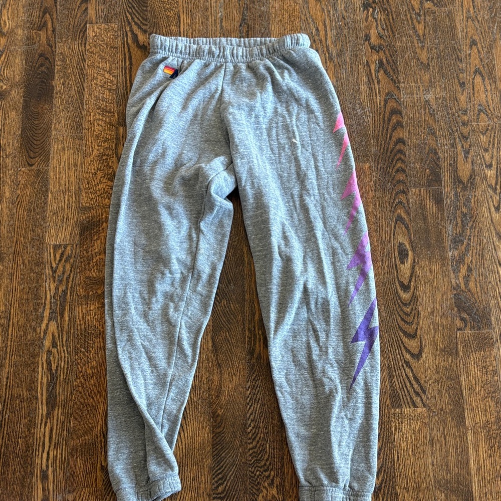 Gray aviator nation sweatpants with pink and purple lightning bolts